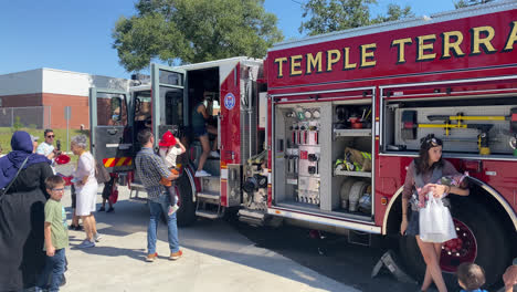 Outdoor-Public-Exhibition-Presentation-of-Fire-Truck-at-Temple-Terrace-Fire-Station-Florida,-People-Visitors-Discovering-the-Firefighting-Vehicle-Equipment
