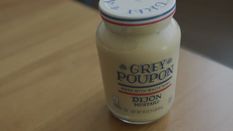 Close-Up-Pan-Right-of-a-Jar-of-Grey-Poupon-Dijon-Mustard