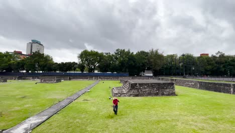 Shot-of-person-cutting-the-grass-at-aztec-pyramids-in-tlatelolco,-mexico-city