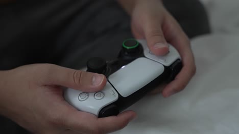 Male-Hands-Holding-PS5-Controller-Pressing-Buttons