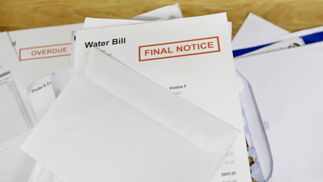 A-pile-of-bills-and-letters-with-a-final-notice-for-a-water-bill-during-a-cost-of-living-crisis