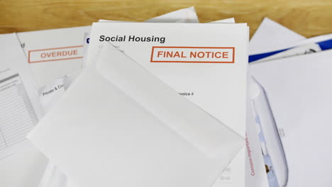 A-pile-of-bills-and-letters-with-a-final-notice-for-social-housing
