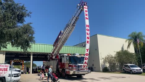 Open-House-Outdoor-Public-Exhibition-Presentation-of-Fire-Truck-at-Temple-Terrace-Fire-Station-Florida,-Visitors-Being-Welcomed-with-Banner