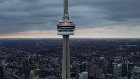 Aerial-view-around-the-CN-Tower,-gloomy-fall-evening-in-Toronto,-Canada---orbit,-drone-shot