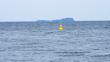 Yellow-Sea-Buoy-in-blue-Sea-at-Rayong,-Thailand