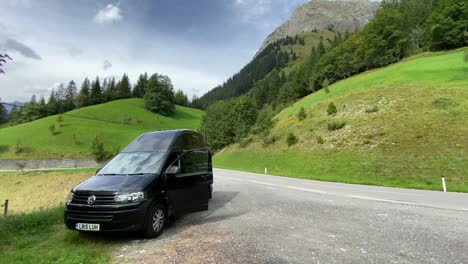 Campervan-parked-by-the-side-of-an-alpine-road-in-the-Alps