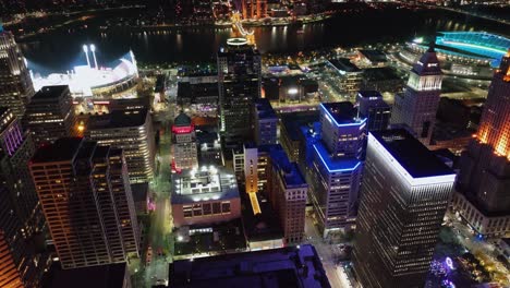 Aerial-view-overlooking-the-lit-up-night-cityscape-of-downtown-Cincinnati,-during-Blink-the-festival-of-lights-and-arts-in-Ohio,-USA---tilt,-drone-shot