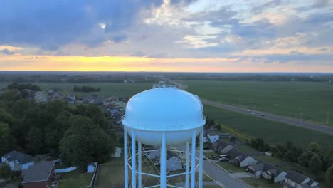 Pushing-backwards-drone-shot-of-the-watertower-in-Clarksville-revealing-downtown-Clarksville