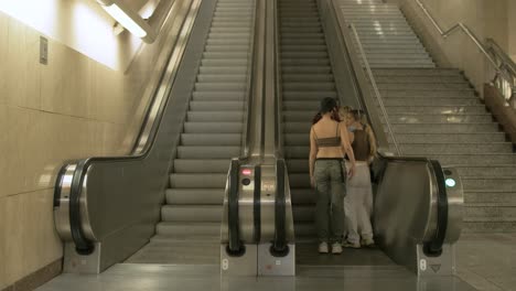 Group-of-girls-take-the-metro-escalator-in-Athens