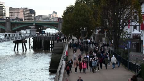 View-of-people-walking-past-Shakespeare's-Globe-from-the-Millennium-Bridge,-London,-United-Kingdom