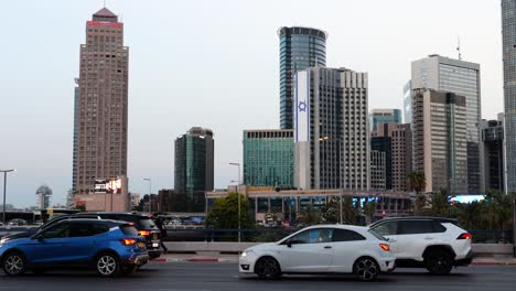 Cars-stopped-in-traffic-jam-on-the-road-in-downtown-Tel-Aviv-Israel,-truck-shot