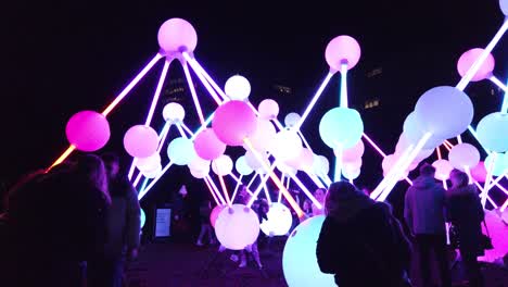 People-interact-with-glowing-Affinity-neuron-touch-artwork,-Chavasse-park,-Liverpool-River-of-light