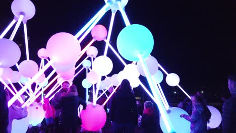 Nightlife-public-interact-with-illuminated-Affinity-neuron-artwork,-Chavasse-park,-Liverpool-River-of-light