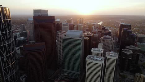 Aerial-view-over-the-Calgary-skyline,-fall-sunset-in-Canada---reverse,-drone-shot