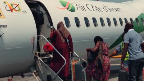 African-Passengers-Boarding-a-Air-Cote-d'Ivoire-Bombardier-DHC-8-Q400-Airplane-at-Abidjan-Félix-Houphouët-Boigny-International-Airport