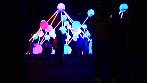 People-interact-with-illuminated-Affinity-neuron-artwork,-Chavasse-park,-Liverpool-River-of-light