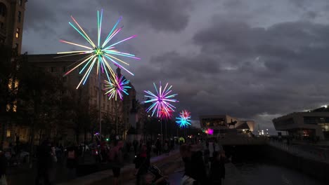Dramatic-flashing-neon-electric-dandelions-artwork-at-Liverpool-pier-head-river-of-light-city-event-at-night