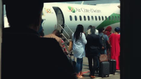 Passengers-Queuing-to-Board-an-Air-Cote-d'Ivoire-Bombardier-DHC-8-Q400-Airplane-at-Abidjan-Félix-Houphouët-Boigny-International-Airport