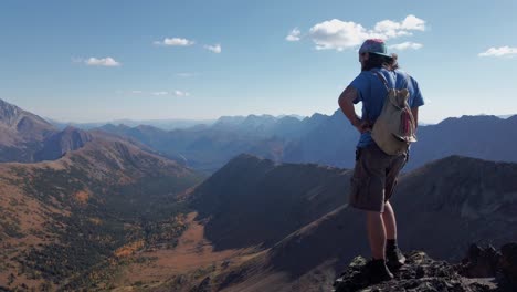 Hiker-on-peak-admiring-mountain-range-Kananaskis-Alberta-Canada