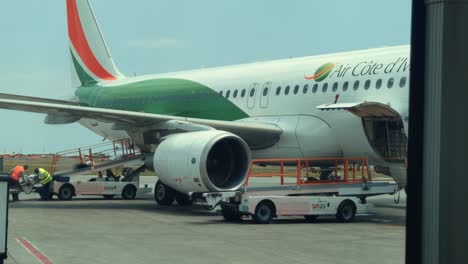Air-Cote-d'Ivoire's-Airbus-A320-at-Abidjan-Félix-Houphouët-Boigny-International-Airport,-view-from-Airport-Bus-Window