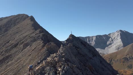 Hiker-climbing-toward-peak-with-spike-slow-motion-revealed-Kananaskis-Alberta-Canada