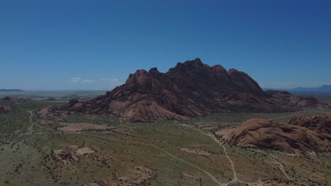 Drone-shot-of-Spitzkoppe-in-Namibia---drone-is-sliding-from-one-mountain-to-another