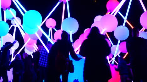 People-in-darkness-interact-with-touch-illuminated-Affinity-neuron-artwork,-Chavasse-park,-Liverpool-River-of-light