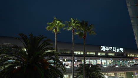 Airplane-Flying-In-The-Night-Sky-Seen-At-Jeju-International-Airport-In-Jeju-City,-South-Korea