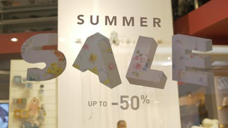Summer-sale-sign-in-storefront-window