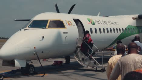 African-Passengers-Boarding-a-Bombardier-DHC-8-Q400-Airplane-at-Abidjan-Félix-Houphouët-Boigny-International-Airport-on-a-sunny-day