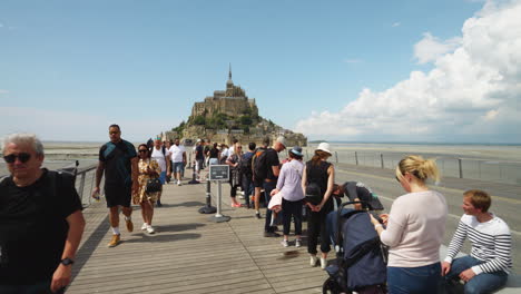 Crowded-People-On-The-Bridge-Connecting-To-The-Mainland-At-Mont-Saint-Michel-In-Normandy,-France