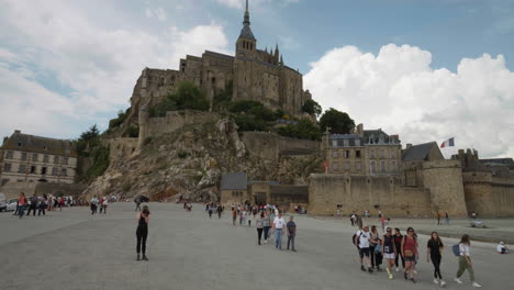 Travelers-On-The-Famous-Mont-St-Michel-Abbey-Towering-On-Rocky-Islet-In-Normandy,-France