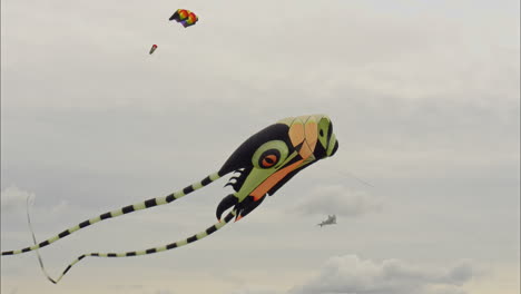 Big-colourful-kite-dances-in-the-sky-at-kite-festival,-Wakefield-UK