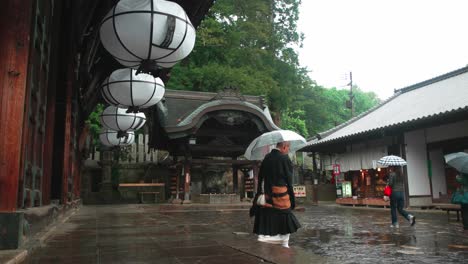 Monk-Walking-Out-Of-Nara-Temple-Under-Rain-Holding-Transparent-Umbrella-in-Japan