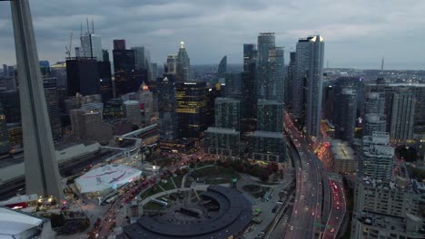 Aerial-view-of-the-train-station,-museum-in-South-Core,-Toronto,-dark-evening-in-Canada---descending,-drone-shot