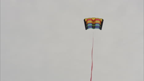 Colourful-Kite-dances-with-the-wind-against-a-grey-sky