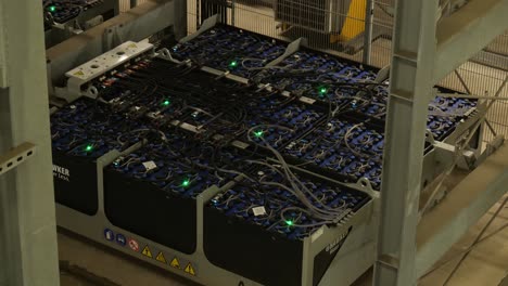 View-Of-Rows-Of-Battery-Pack-Modules-Laid-Out-And-Connected-To-Each-Other-With-Wires-And-Green-LED-Status-Light