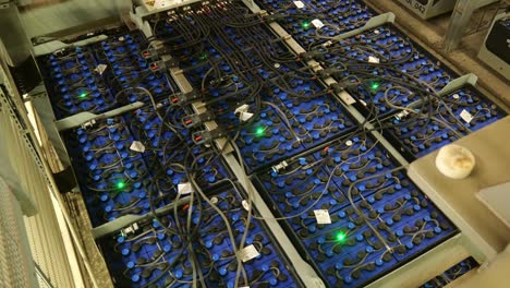 Rows-Of-Battery-Packs-Laid-Out-And-Connected-To-Each-Other-With-Wires-And-Green-LED-Status-Light