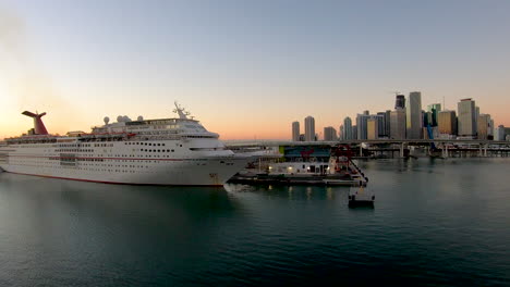 Carnival-Ecstasy-cruise-ship-docked-on-port,-Miami-city-skyline-view-with-Carnival-Ecstasy-cruise-ship-docked-on-port