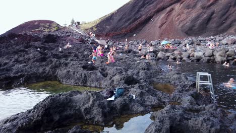 Volcanic-Coast-in-Azores-with-People-Taking-Bath-in-Thermal-Spring