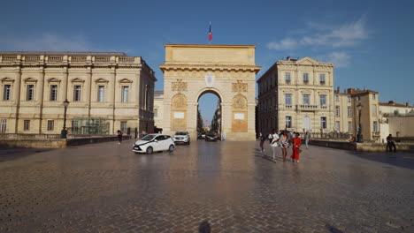 Escena-De-Gente-Caminando-Frente-Al-Arco-Del-Triunfo-En-Montpellier,-Francia