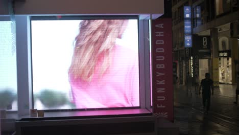 Trendy-video-advertisement-in-storefront-window-Ermou-street-Athens