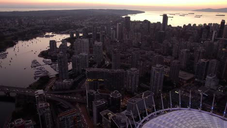 Yaletown-cityscape-and-the-BC-Place-Stadium,-dusk-in-Vancouver,-Canada---aerial-view