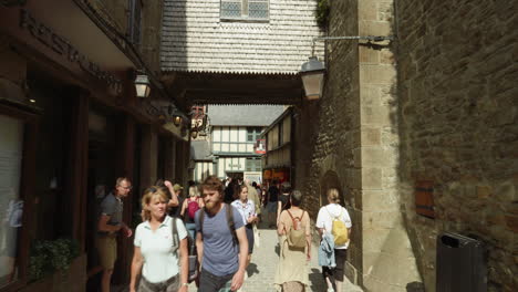 Crowded-People-On-The-Busy-Street-Of-Le-Mont-Saint-Michel-Village-In-Manche,-Normandy,-France