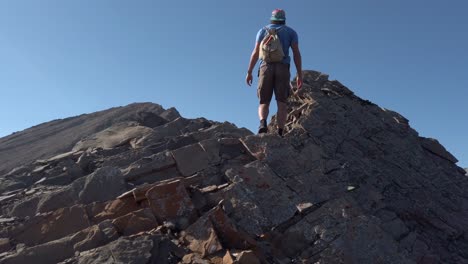 Hiker-climbing-up-mountain-rock-looking-forward-slow-motion-Kananaskis-Alberta-Canada