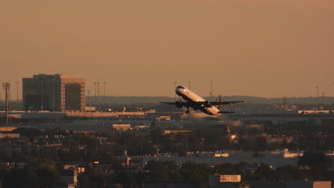 Establishing-scenery-of-Airplane-taking-off-during-golden-hour-sunset-at-Toronto-YYZ-Airport