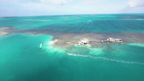 TWO-MEN-kiteboard-CROSS-RIGHT-TO-LEFT,-drone-shot-PALAFITO-LOS-ROQUES