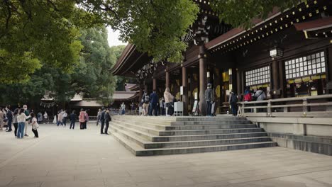 Shinto-Japanese-Shrine,-Meiji-Jingu-as-people-gather-to-Pray