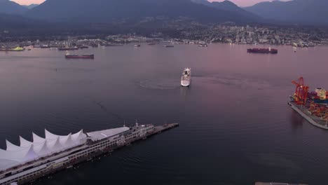 Cruise-liner-leaving-on-the-Vancouver-Harbor,-colorful-evening-in-Canada---Aerial-view