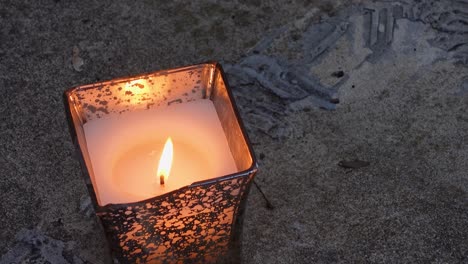 Single-Lighted-Candle-In-Metallic-Can,-Waving-Flame-In-Wind